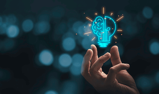A hand beneath a glowing lightbulb icon containing a brain, representing an AI idea.