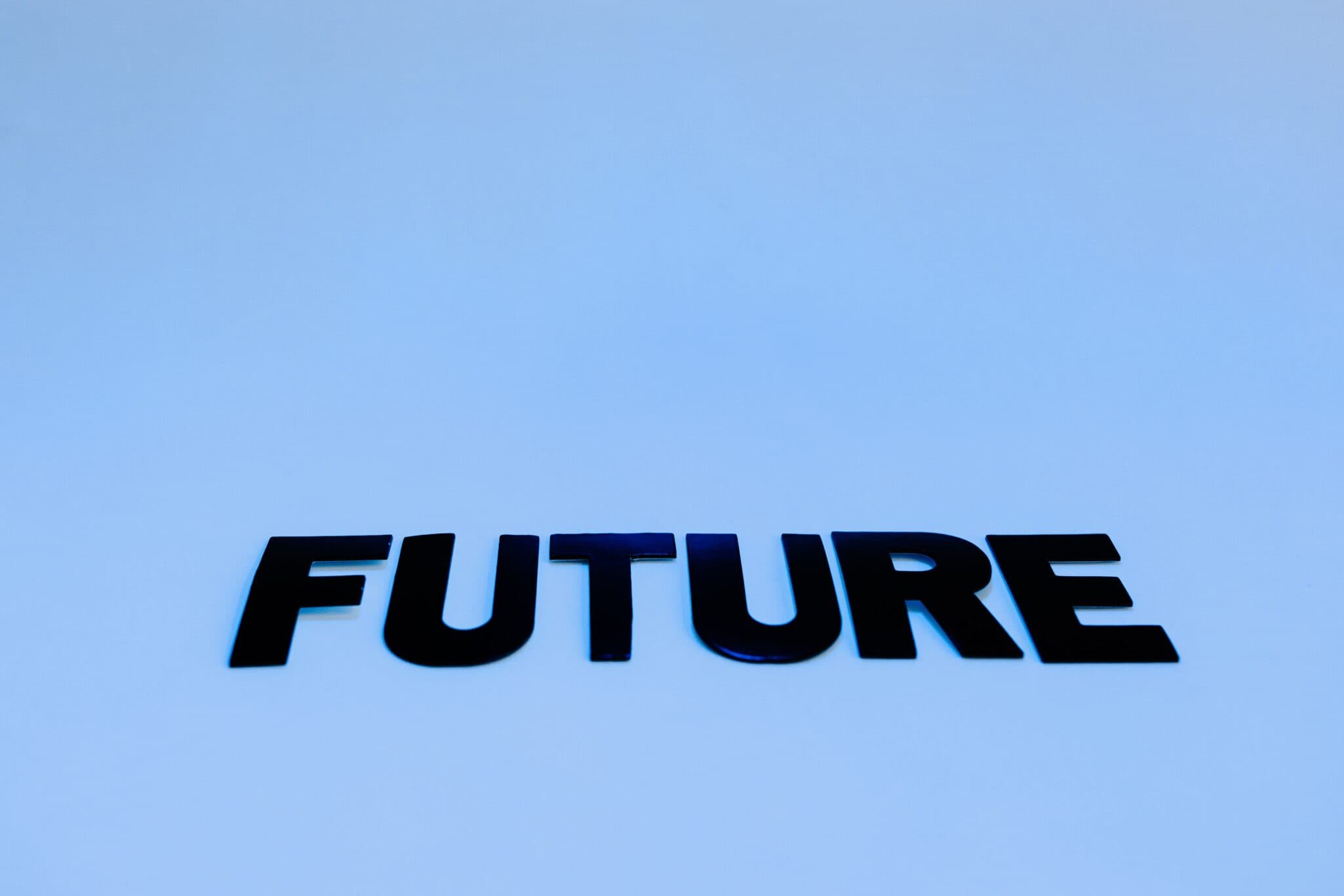 The Word Future " is Written in Black Capitals on a plain Blue Background