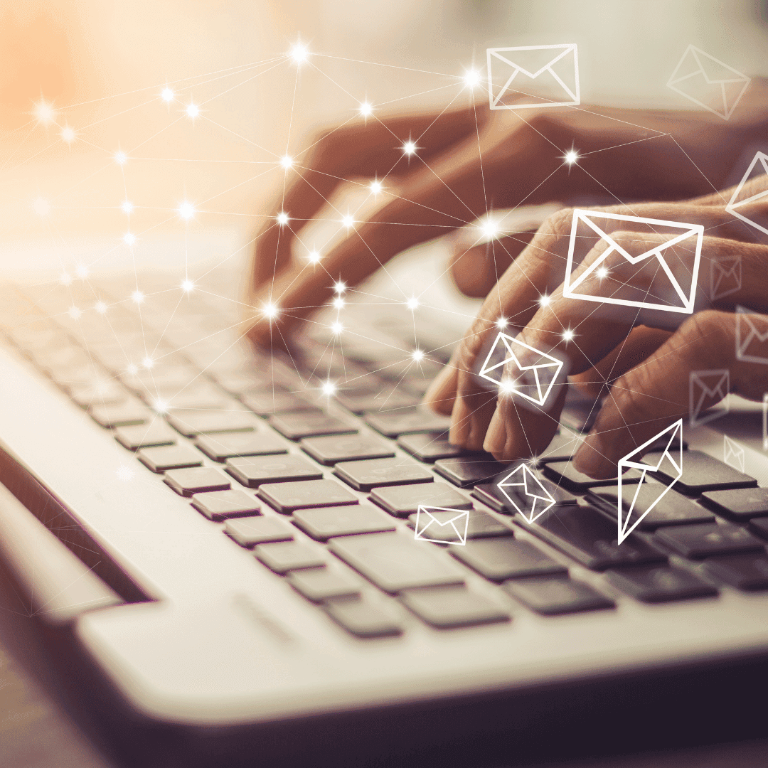 Hands typing on a laptop with illustrated envelope icons floating above the keyboard.