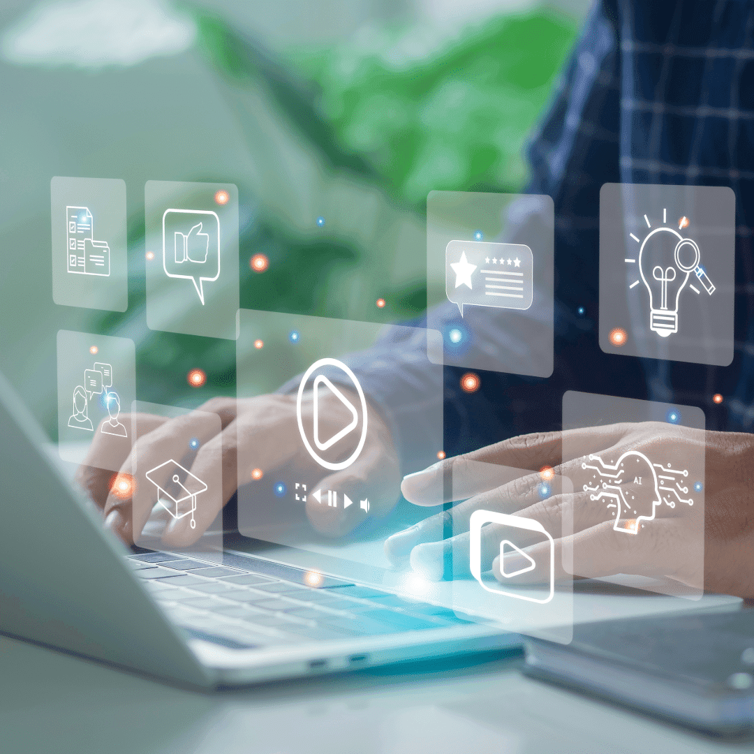 Hands on a laptop surrounded by floating icons for video, content and ideas.