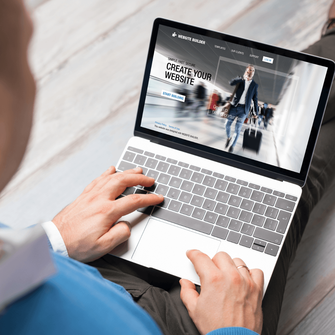 A man using a laptop showing a website builder page headed Create Your Website.