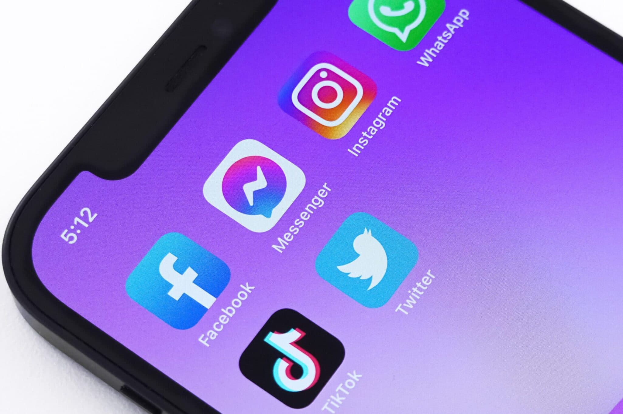 Close-up of a phone home screen showing social media app icons including Instagram, Facebook, Messenger and TikTok.