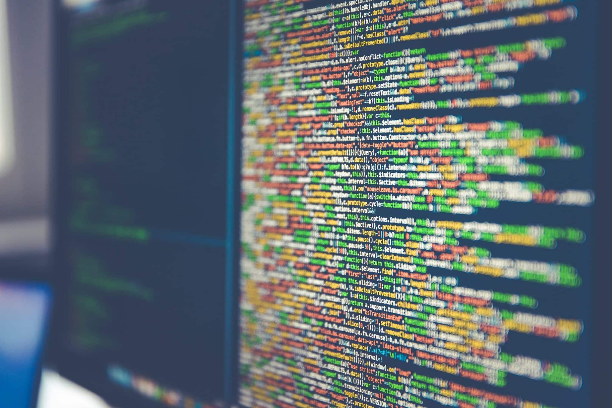 A computer monitor filled with colourful lines of code.