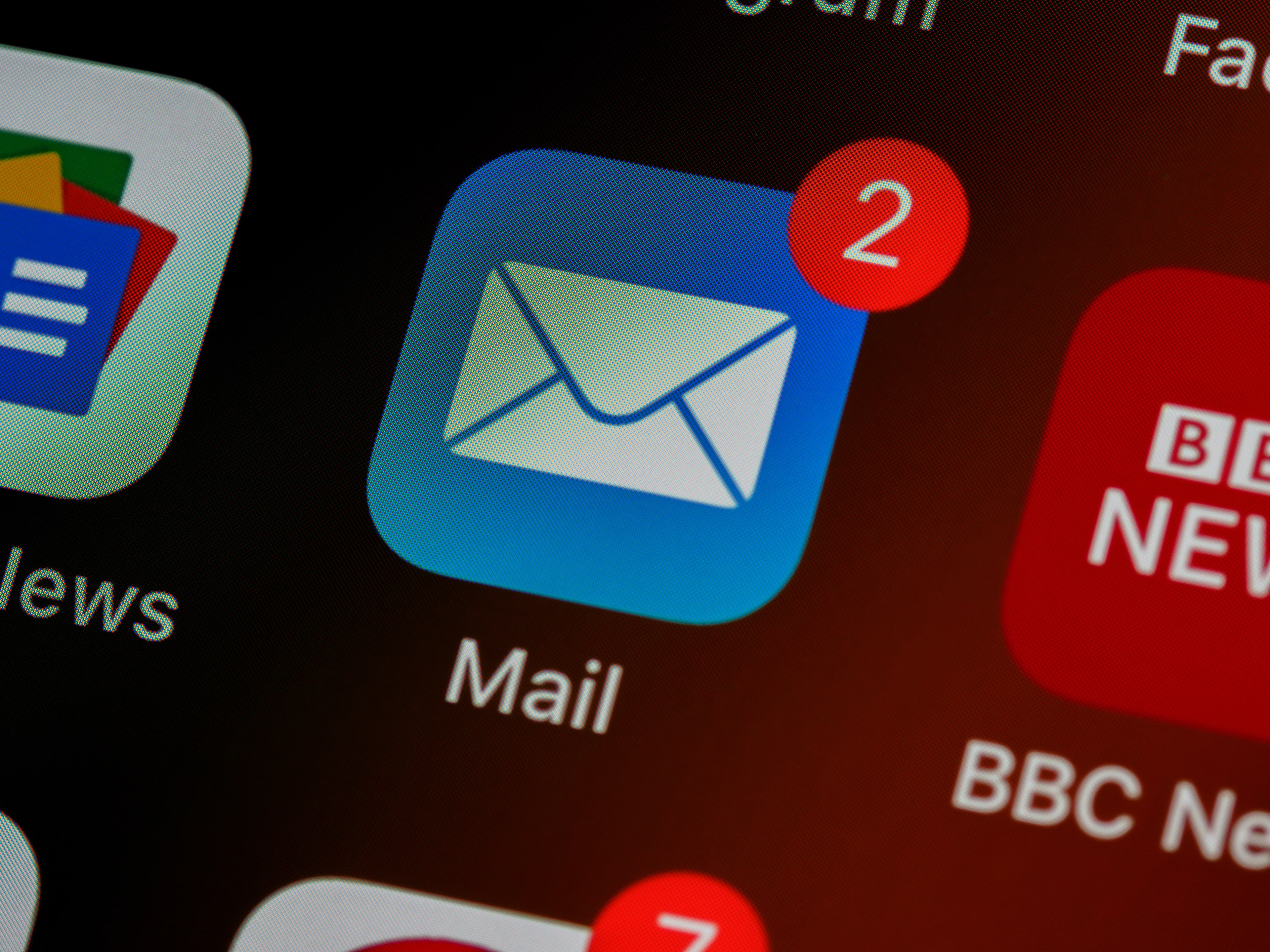 Close-up of a phone home screen showing a Mail app icon with two unread notifications.
