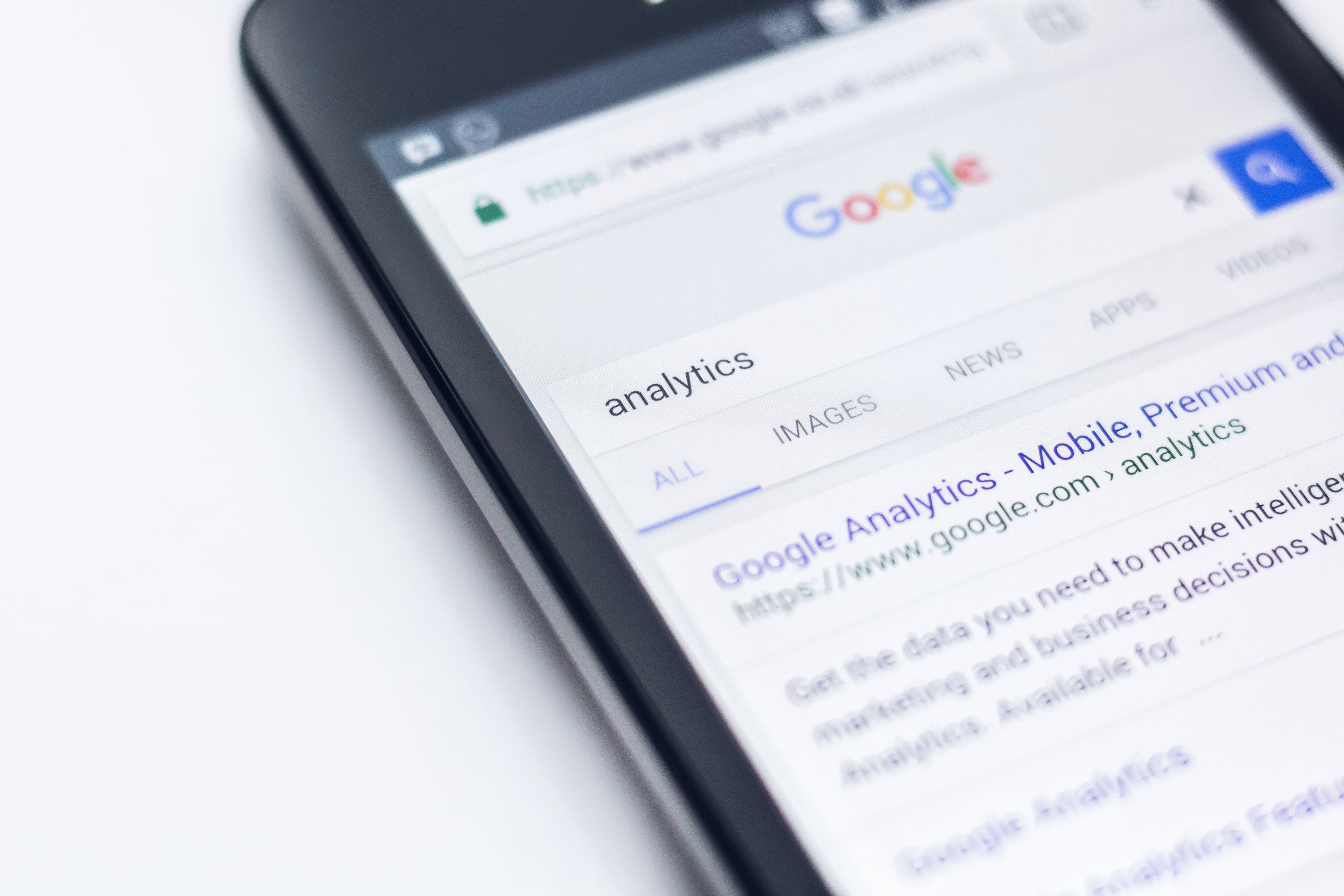 A phone showing Google search results for the word analytics.