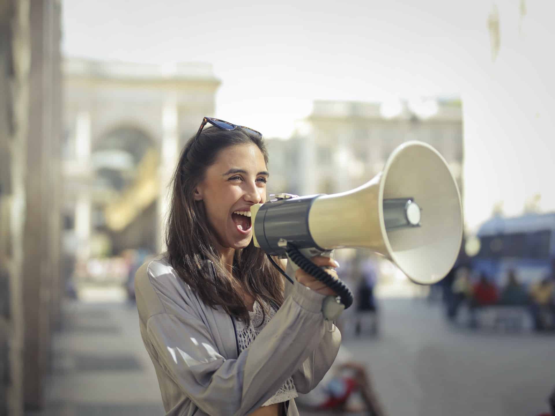 woman talking into a loud speaker